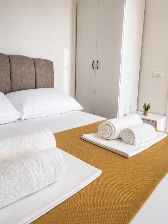 a bedroom with two beds with towels on them at Apartmani Morѐll 1 in Novalja