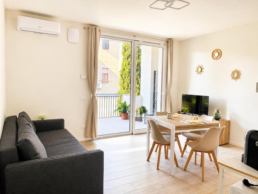 a living room with a couch and a table at La Curt by Ambroeus apartments in Inzago