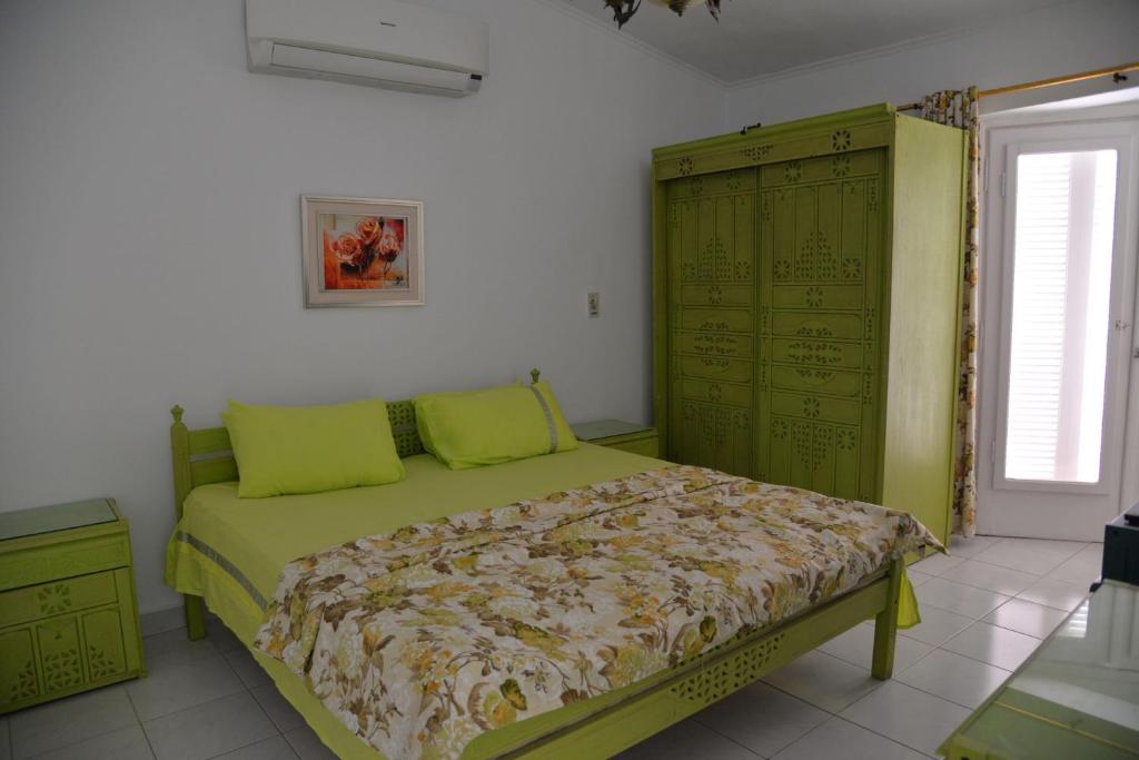 a bedroom with a bed and a green cabinet at Virginia beach village in El Alamein
