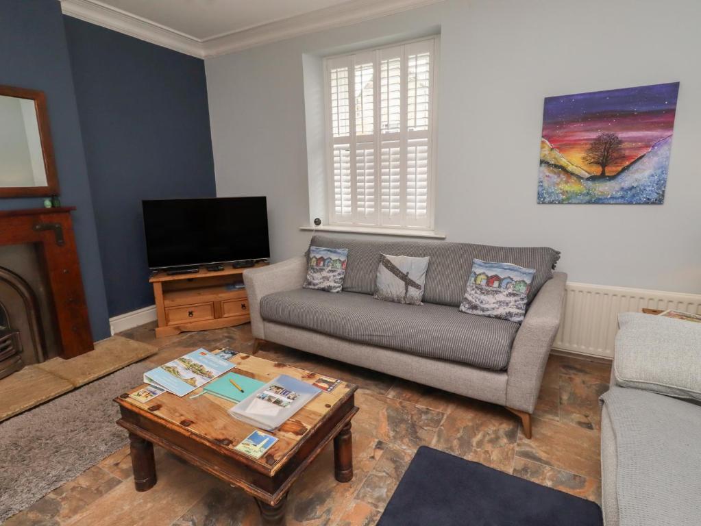 a living room with a couch and a coffee table at Number Seventeen in Amble