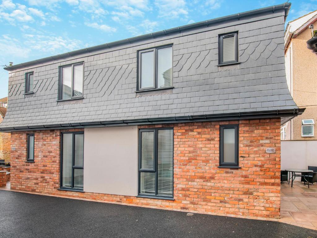 a brick house with a gray roof at Dunlin in Filey