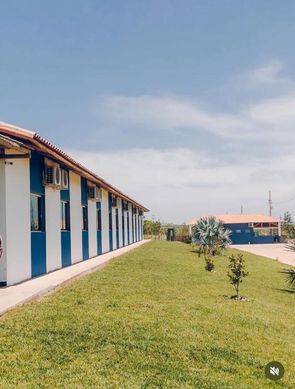 ein Gebäude mit einer Rasenfläche neben einem Gebäude in der Unterkunft Aguazul Hotel in Augusto de Lima