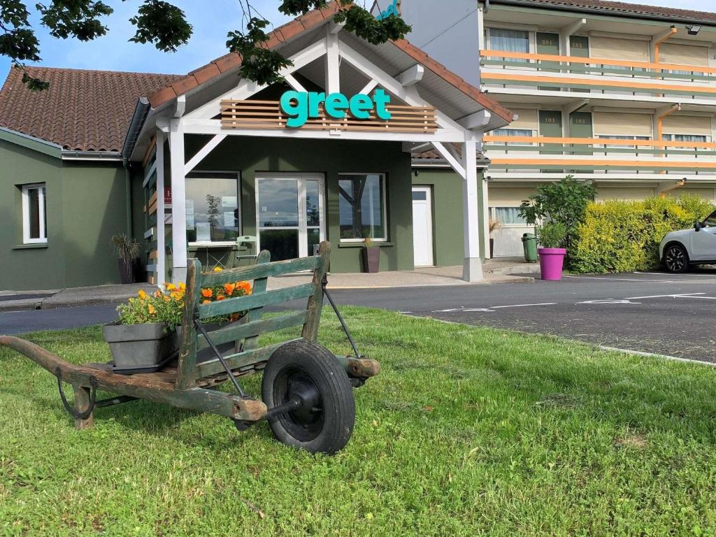 a cart in the grass in front of a store at greet Hotel Belleville en Beaujolais A6 in Belleville-sur-Saône