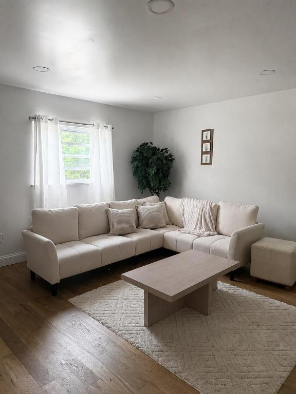 a living room with a white couch and a coffee table at Homestead Bungalow in Dayton