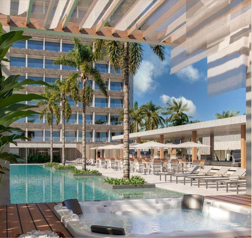 an exterior view of a hotel with a swimming pool at Apartamento no Beach Resort Salinas in Ilha de Atalaia