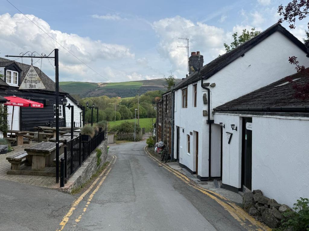 an empty street in a village with at Triangle Inn Coachouse in Rhayader