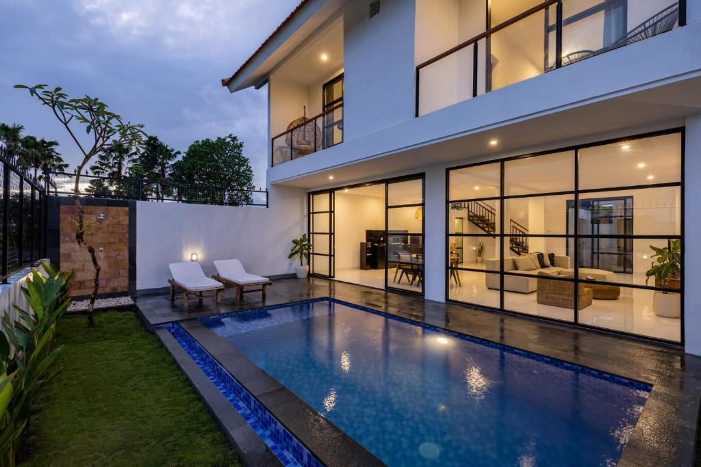 a swimming pool in front of a house at Villa Alba by Orivista, Rice Field View in Dalung