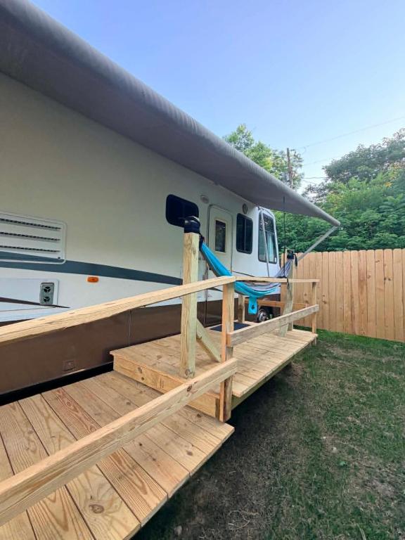 a rv with a porch and a ramp next to it at comfortable home on wheels in Gadsden
