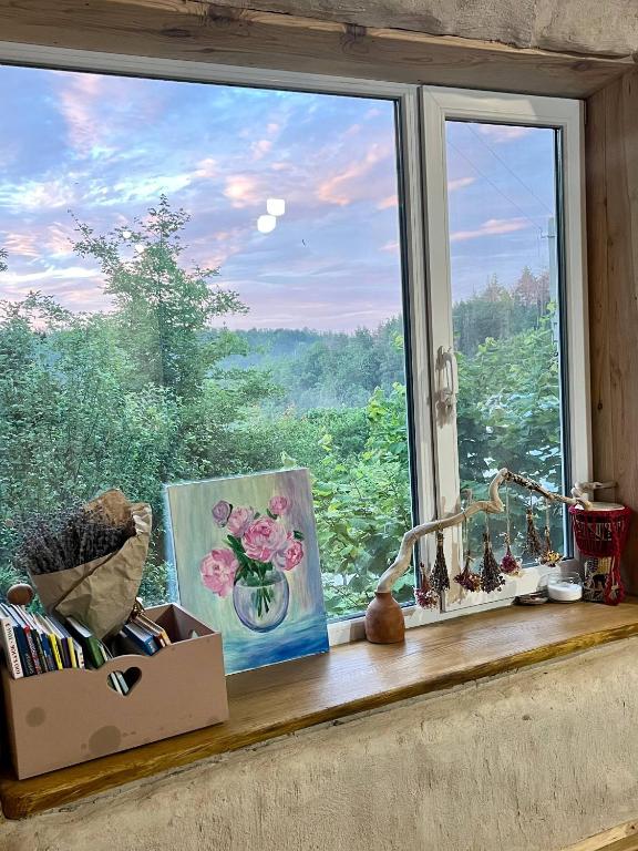 a window sill with a picture of a view at Простір Джерело Гармонії in Kaniv