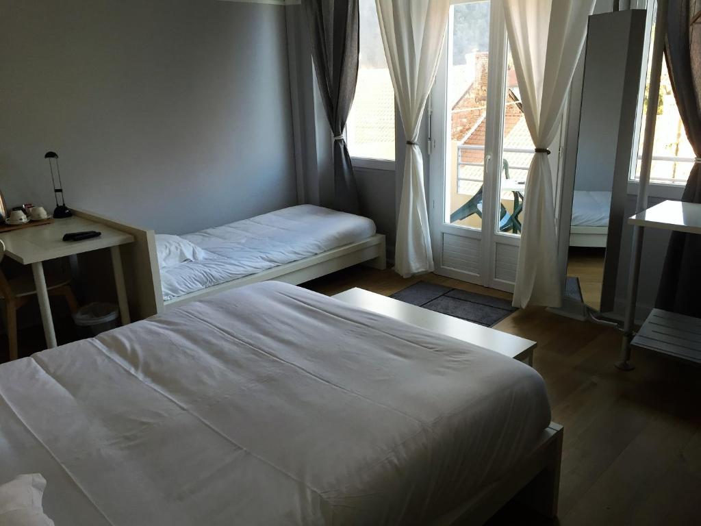Postel nebo postele na pokoji v ubytování Cafe de Paris
