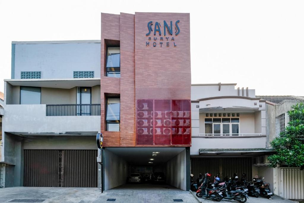 a building with motorcycles parked in front of it at SANS Vibes Surya in Stasiun Tawang