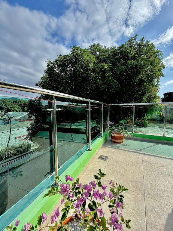 a balcony of a house with purple flowers at Hostal La Marina in Santa Marta