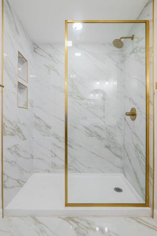 a shower with a glass door in a bathroom at Rustic Private Studio Near Downtown Worcester in Worcester