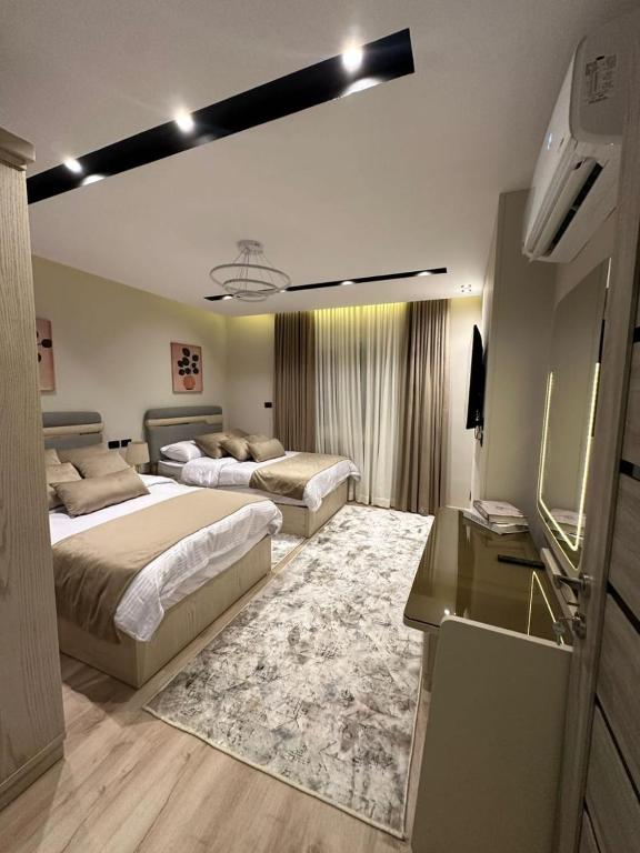 a hotel room with two beds and a kitchen at Charming Miramar Aparthotel in Alexandria