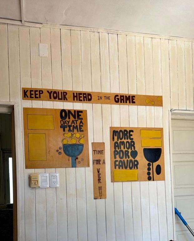 a wall with signs on it with a door at la casita del altillo in San Francisco