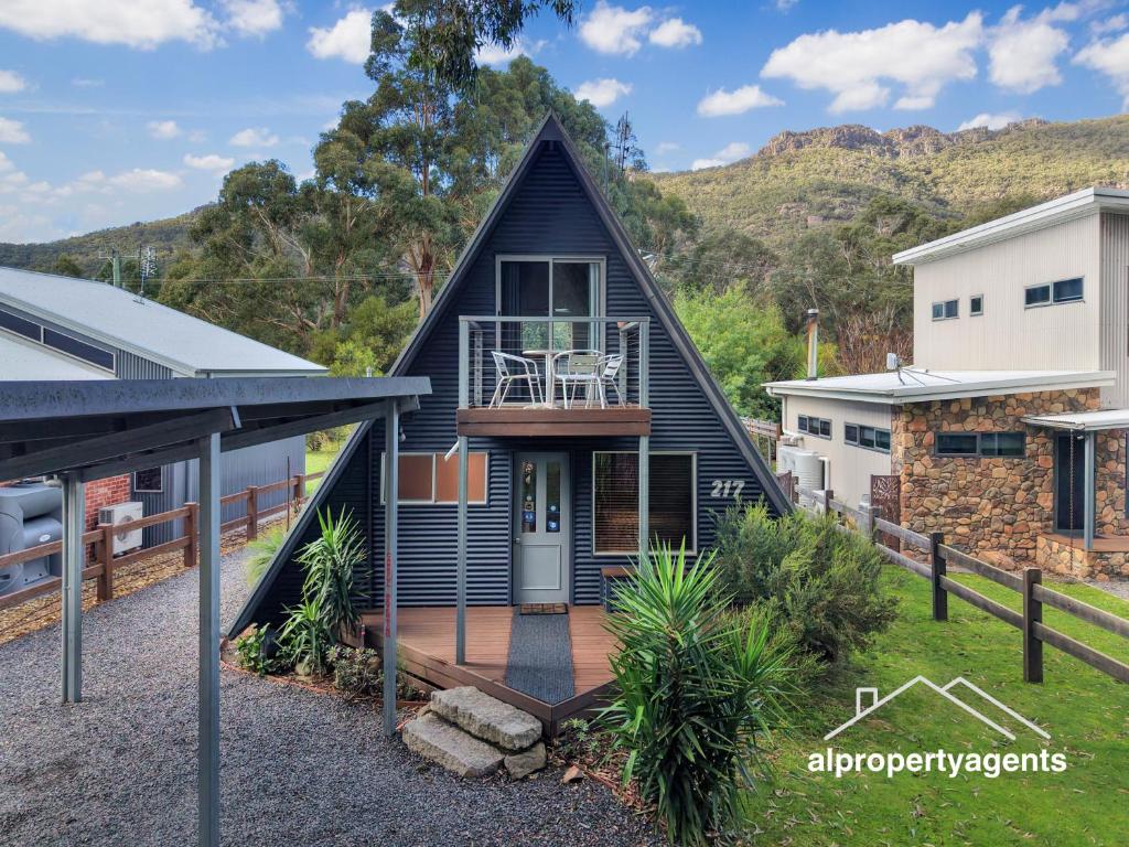a house with a gambrel roof with a deck at The A-Frame in Halls Gap