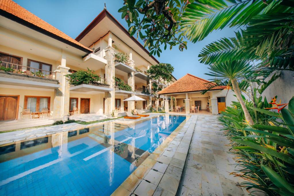 an image of a villa with a swimming pool at New Puri Asih Hotel in Kuta