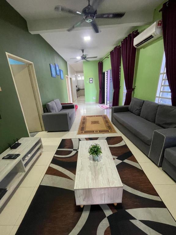 a living room with a couch and a table at Deeja Homestay Kuantan in Kuantan