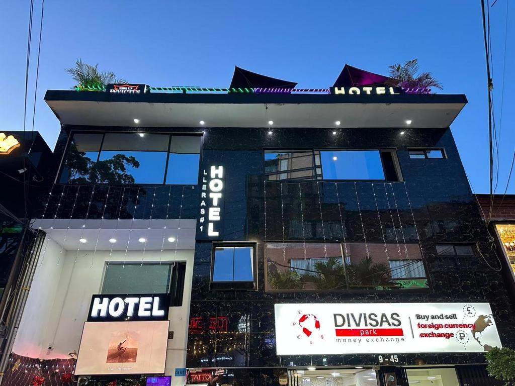 a hotel building with a sign in front of it at Hotel Lleras # 1 in Medellín