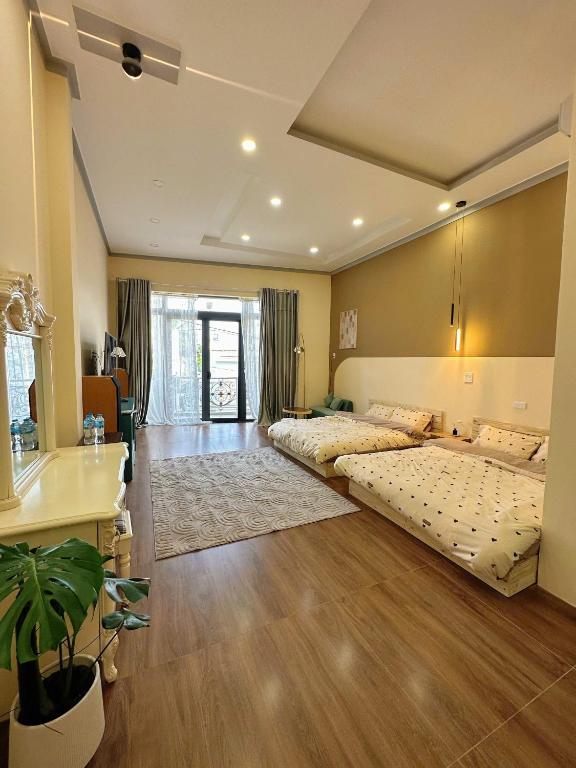 a large room with two beds in it at Phố Homestay Phan Thiết in Phan Thiet