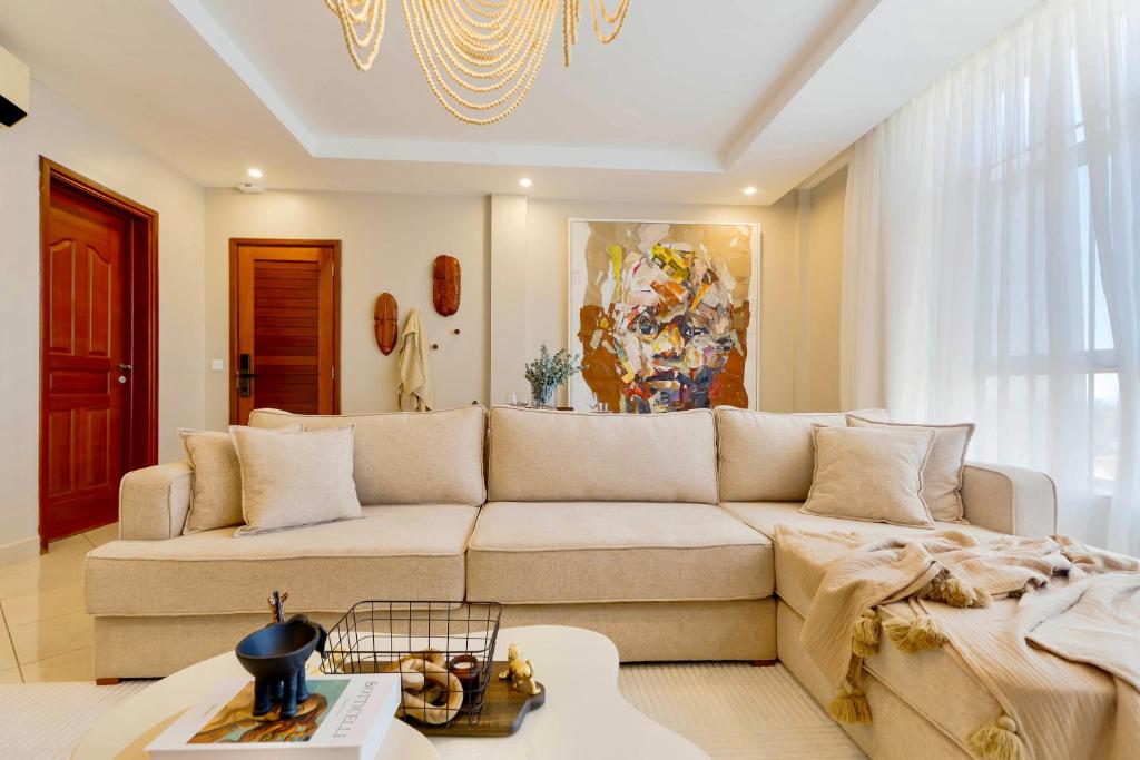 a living room with a couch and a table at Naia Residence - 2BR Oceanview in Dar es Salaam