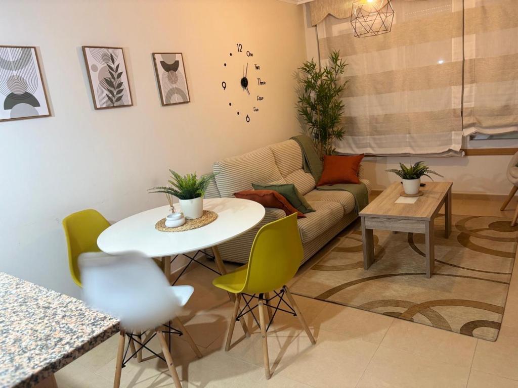 a living room with a table and a couch at A&M Burela Costa in Burela de Cabo