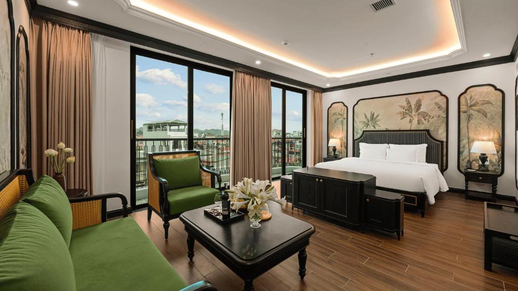 a bedroom with a bed and a living room at MT Collection Legacy Hotel Ninh Binh - Near Hoa Lu Ancient Town with Rooftop Pool in Ninh Binh