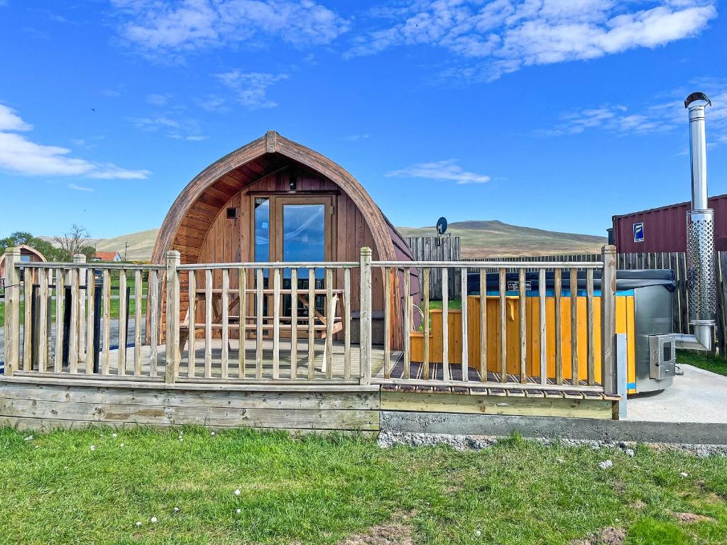 a small wooden cabin behind a wooden fence at Selker View-Uk1397 in Corney