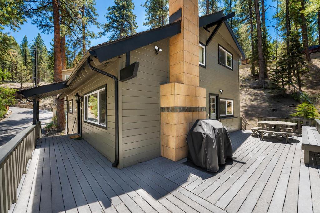 a house on a wooden deck with a building at Foothill Folly home in Zephyr Cove