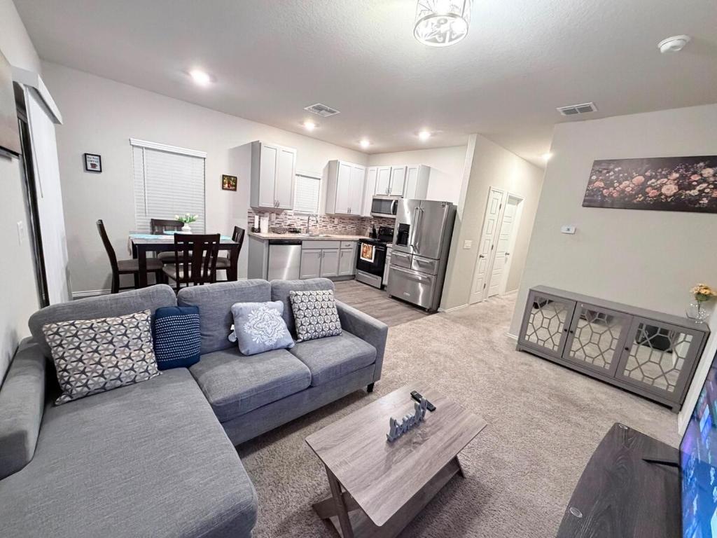 a living room with a couch and a table at Cozy Retreat in San Antonio