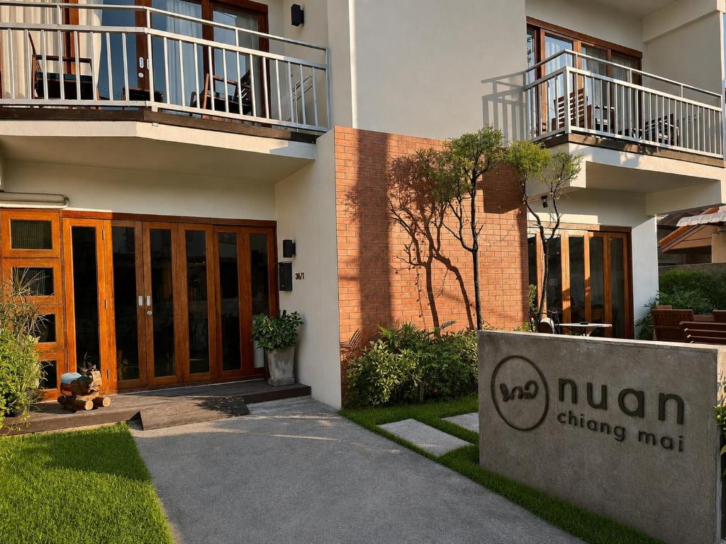 a building with a sign in front of it at Nuan Boutique Hotel in Chiang Mai