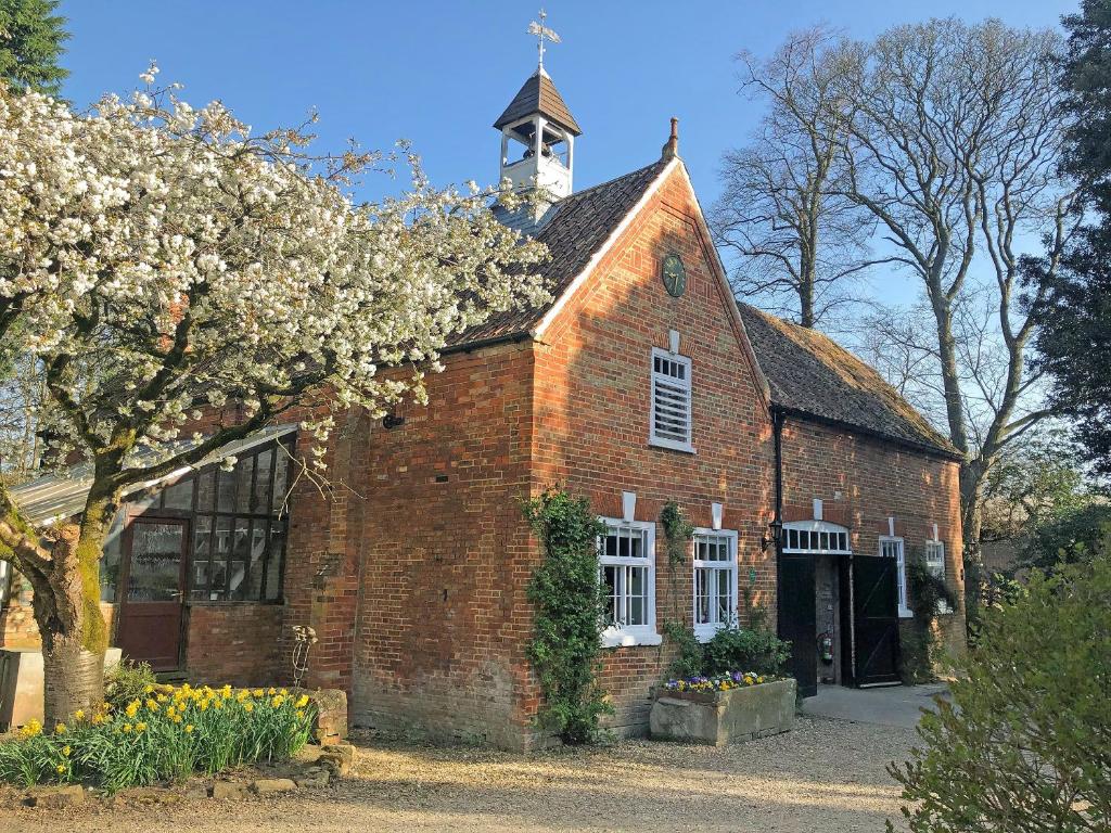 an old red brick building with a tower on top at Saddle Room - Uk51017 in Louth