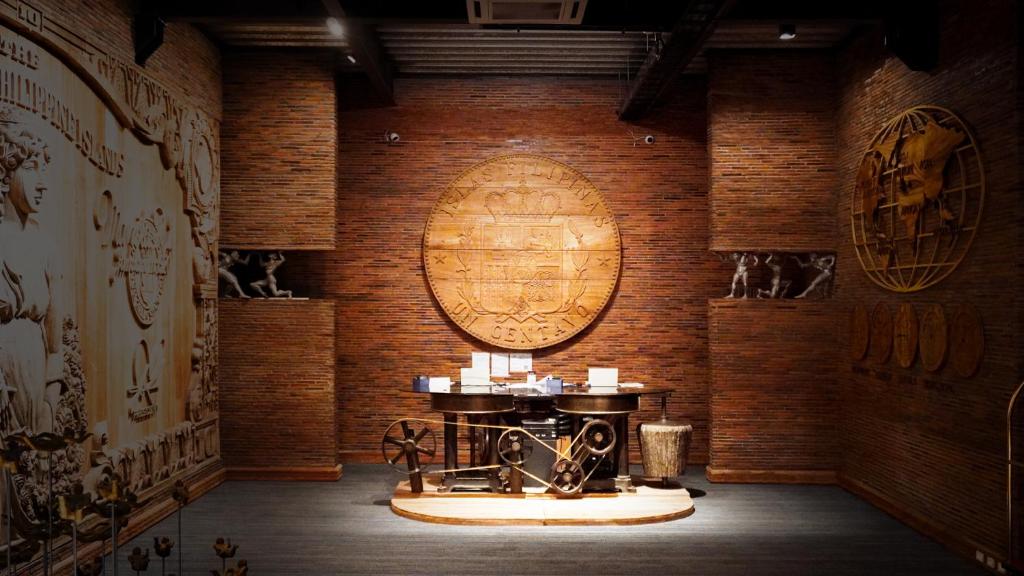a room with a table and a wooden wall at VS Hotel in Manila