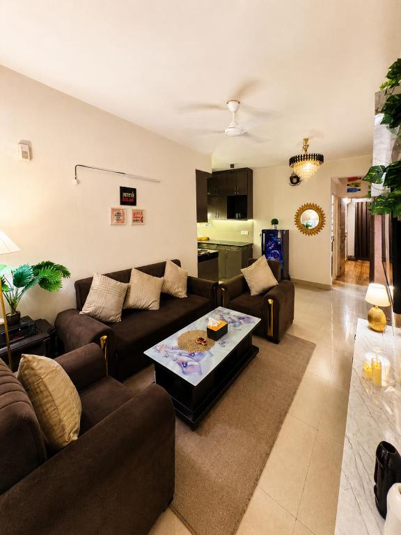 a living room with two couches and a coffee table at Ballentines Bliss in Babarpur