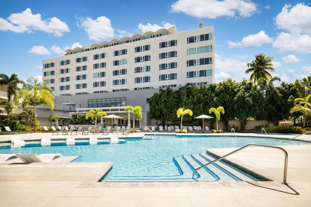 a hotel with a pool in front of a building at Hyatt Centric San Juan Isla Verde in San Juan