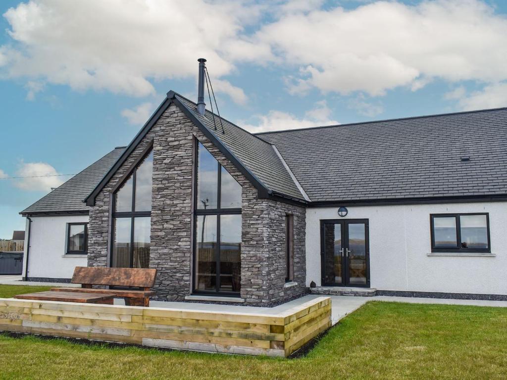 a house with a bench in front of it at Ryka Lodge in Back