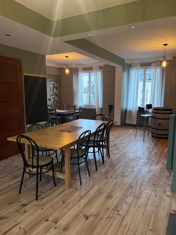 a conference room with a wooden table and chairs at Le Kompost'l chambre en gîte 2 pers in Saint-Privat-dʼAllier