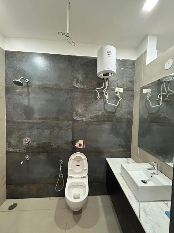 a bathroom with a toilet and a sink at Balaji villa in Juliāsar