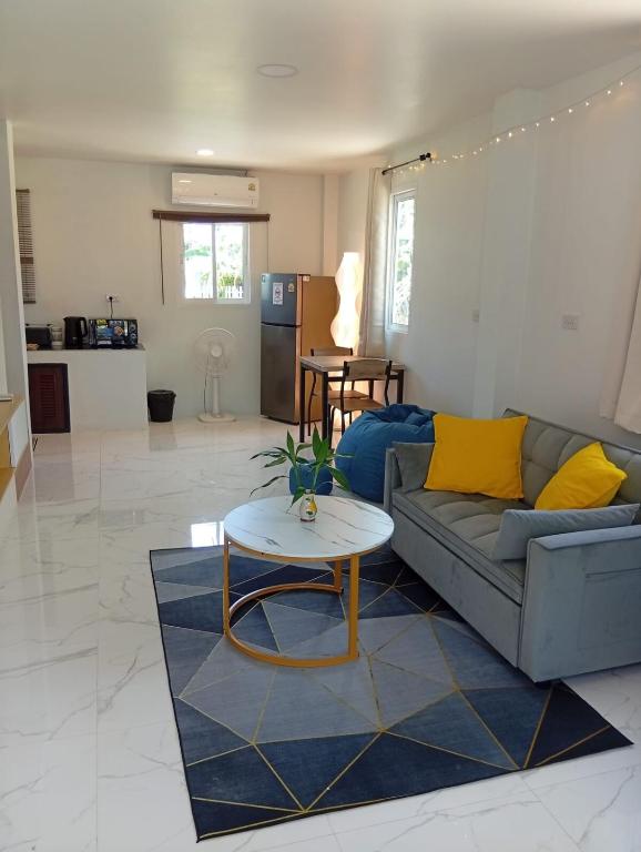 a living room with a couch and a table at Stylish 1BR Retreat with Workspace & Hammock in Hinkong