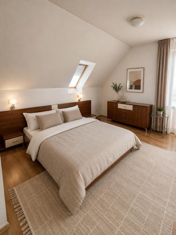 a large bedroom with a large bed and a skylight at Veľký rodinný apartmán s výhľadom na zeleň a hory v centre Piešťan s parkovaním in Piešťany