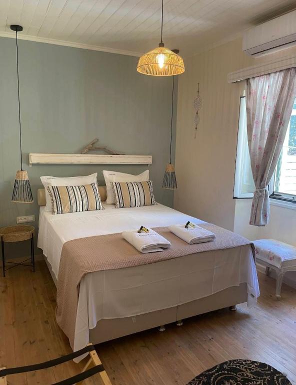 a bedroom with a large bed with two towels on it at Casa Tereza in Plátanos