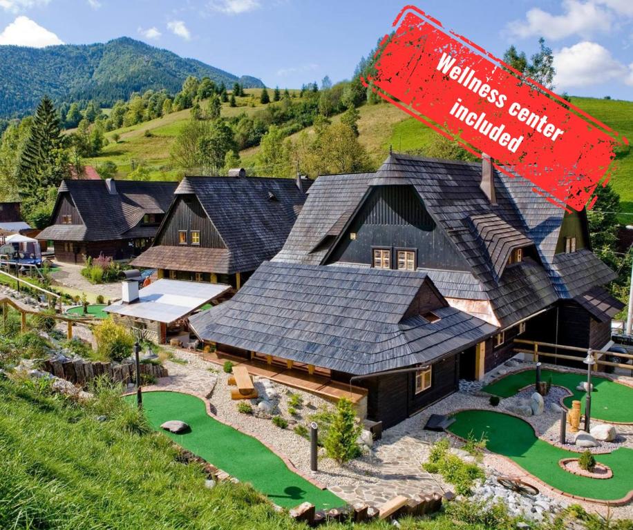 an aerial view of a house with a golf course at Wellness rezort Jánošíkov dvor in Zázrivá