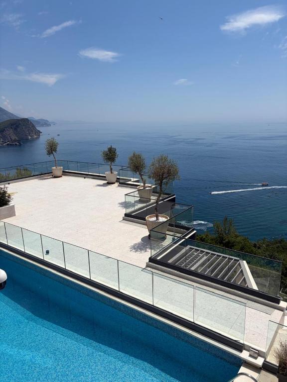 a swimming pool with a view of the ocean at Villas Vita & Dola in Budva