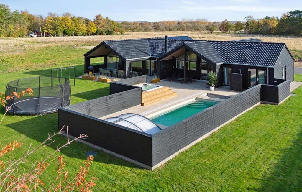 a house with a swimming pool in the yard at Gorgeous Home In Højby With Kitchen in Højby