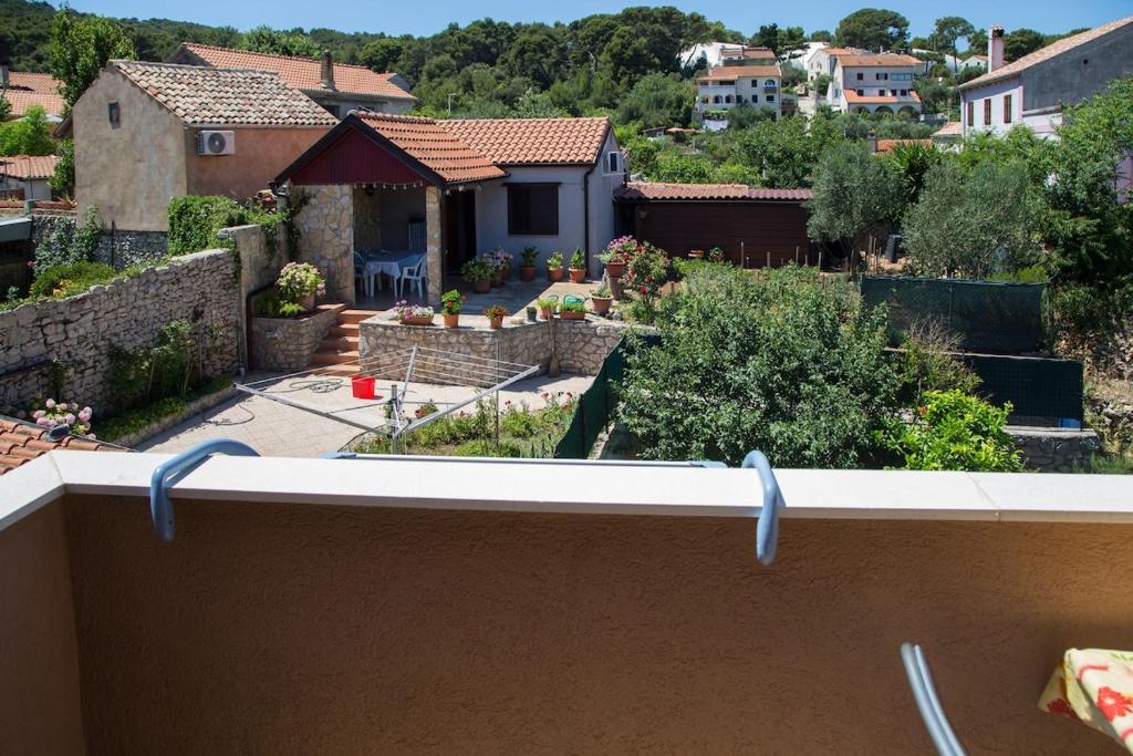 a view from the balcony of a house with a garden at Marea in Veli Lošinj