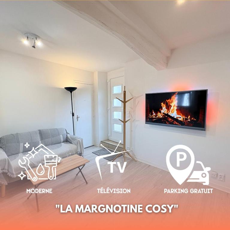 a living room with a couch and a fireplace at La Margnotine Cosy in Margny-lès-Compiègne