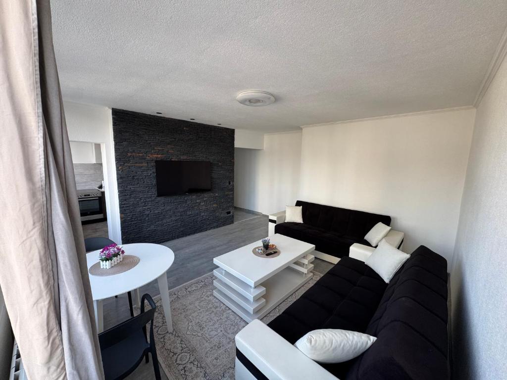 a living room with a couch and a table at Apartman Tuzla in Tuzla