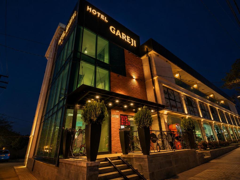 a building with a sign on the front of it at Hotel Gareji Kakheti in Sagarejo