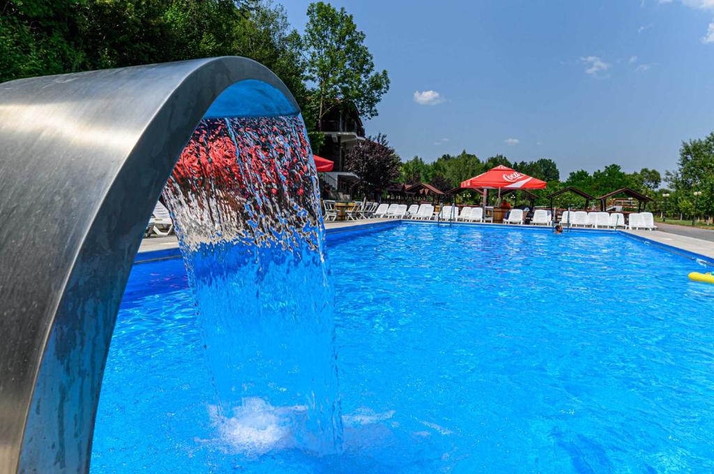 a water slide in a swimming pool at Deny Inn Harmony in Zărneşti
