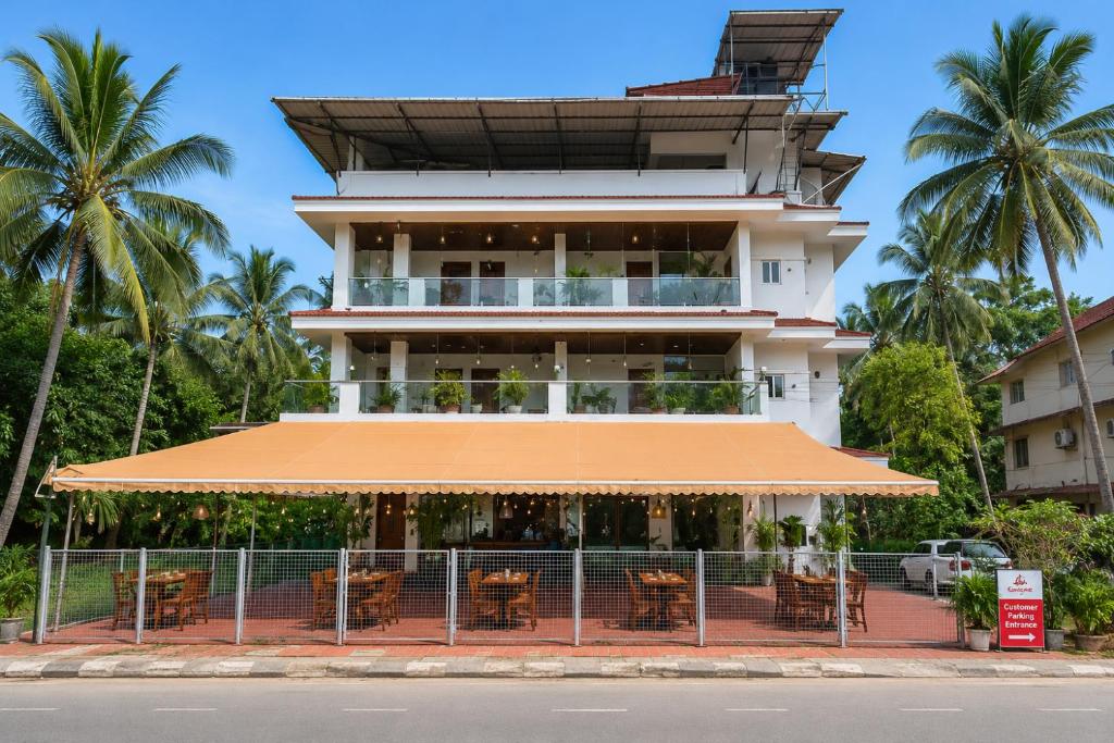 a building with tables and chairs in front of it at Goa Villagio Hideaway in Majorda